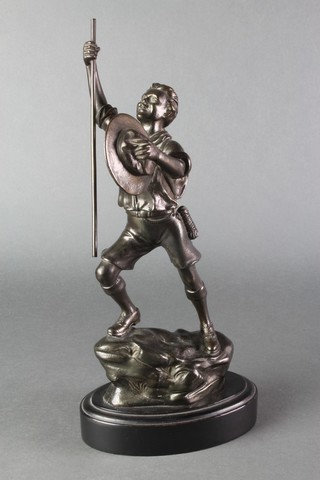 A spelter figure of a standing boy scout raised on an oval base 12" 