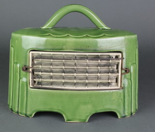 A 1930's electric fire contained in a boat shaped green glazed porcelain case 11 1/2"h, this lot is to be sold for decorative purposes only