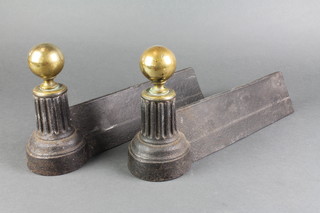 A pair of Victorian iron fire dogs with brass finials 