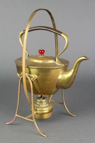 An Art Nouveau oval brass tea kettle on stand complete with burner and horn handle 
