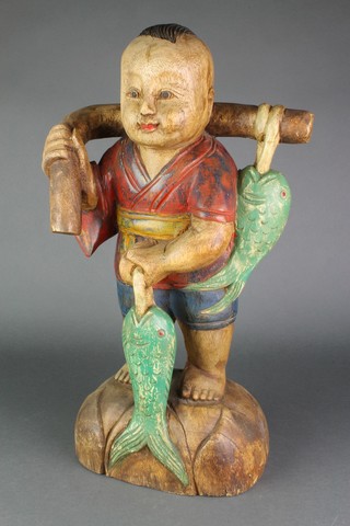 A Chinese carved wooden figure of a standing fisherman 21"h 