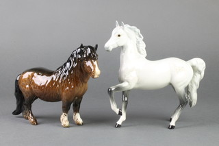 A Beswick figure of a grey dappled horse 7", a ditto of a Shetland pony 8" 
