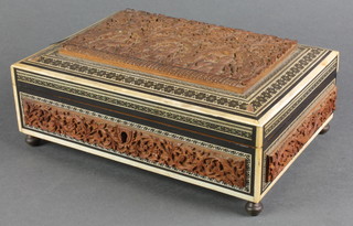 An Indian carved hardwood box with mother of pearl banding, raised on turned brass feet 3"h x 9"w x 6 1/2d 