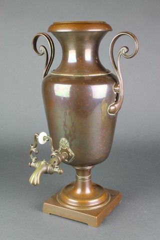 A 19th Century copper twin handled tea urn, raised on a square base 16 1/2" 
