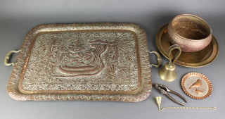 A rectangular Indian embossed brass twin handled tea tray 24" x 17 1/2", a circular brass tray etc