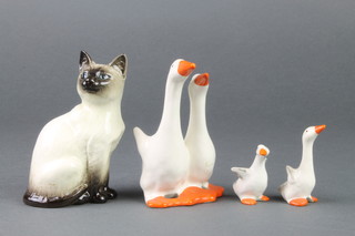 A Beswick group of 2 geese together with 2 goslings and a seated figure of a siamese cat