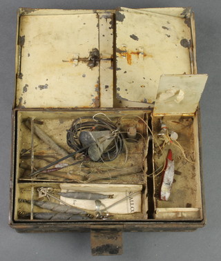 A black metal lure box containing various lures and flies 