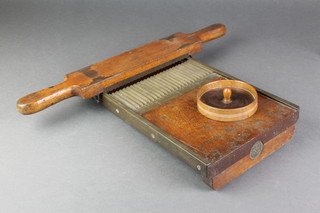 A 19th Century Thompson iron and brass banded pill roller, together with a circular turned wooden pill dish 4" 