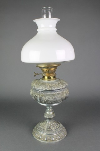 A Victorian cast metal oil lamp base with opaque glass shade and chimney 