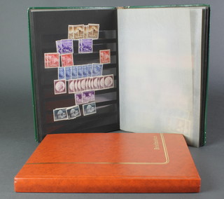 A green stock book of various German stamps - mint and used and an orange stock book of various mint German stamps 
