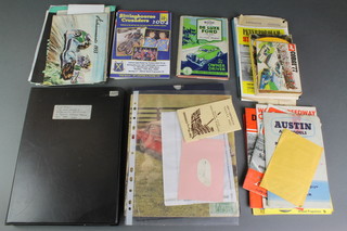 Stirling Moss, a signed autograph, together with a box containing various motoring programmes, Isle of Man and other related ephemera