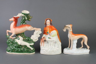 A Staffordshire figure of Little Red Riding Hood 9", a ditto of a hound with a hare in its mouth 7" and a spill vase of a deer and hound 11" 