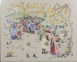 A framed embroidery of a market scene 16 1/2" x 20 1/2" 