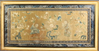 A framed Chinese silk work embroidery of figures in a garden 15" x 31" 