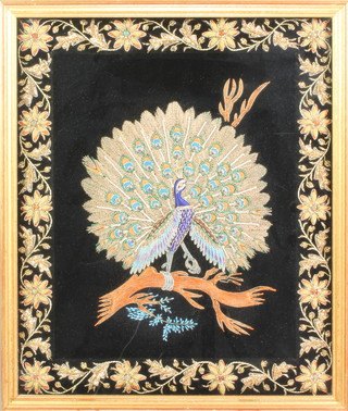 A framed Indian boulle work embroidery of a peacock within a formal scrolling floral border set with hardstones 18" x 15" 