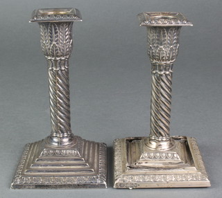 A pair of Victorian repousse silver dwarf candlesticks with stepped bases, Sheffield 1894, 5" 