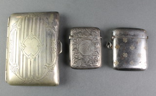 An Edwardian silver vesta, Birmingham 1900, a plated ditto decorated with shamrocks and a cigarette case 