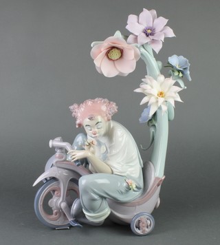 A Lladro figure of a clown riding a tricycle no. 199/1000 decorated by J Ruiz, boxed and with certificate 13" 