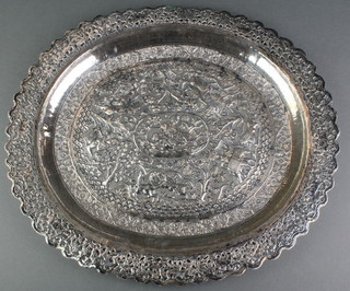 An Indian repousse and pierced silver oval dish with a lion hunting scene 540 grams 