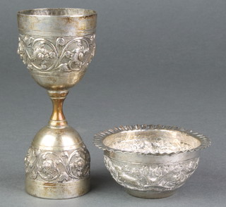 An Indian repousse silver double cup measure and a ditto bowl decorated with animals 