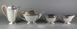 An Art Deco 4 piece silver tea and coffee service with fruitwood mounts, Sheffield 1934, gross 1920 grams