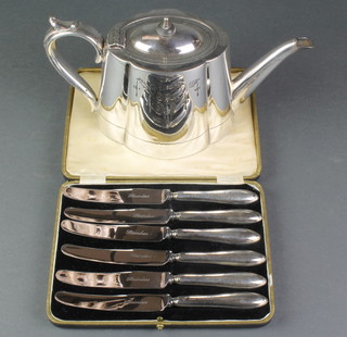 A cased set of 6 silver handled butter knives and a plated teapot 