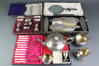 A boxed silver egg cup, a silver condiment set, a silver plated backed brush set and other minor plated items 