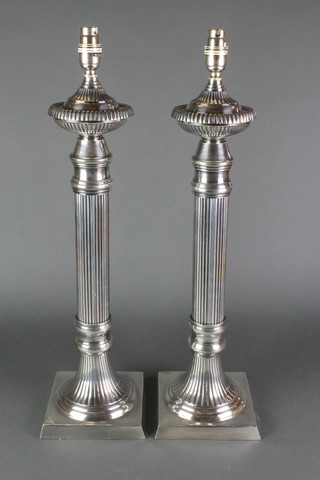 A pair of column silver plated table lamps on square bases 23"