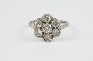 A platinum diamond 7 stone cluster daisy ring, size M