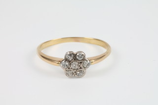 A yellow gold 7 stone diamond cluster ring 