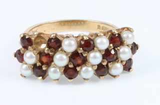 A 9ct yellpw gold garnet and pearl dress ring, size O