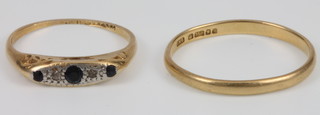 An 18ct gold wedding band, size U and a sapphire and diamond 18ct gold ring size N