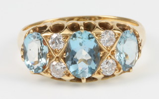 An 18ct yellow gold aquamarine and diamond ring, size L