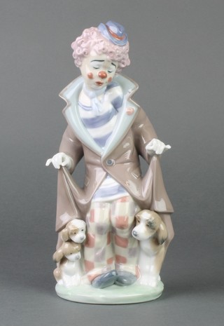 A Lladro figure of a clown with dog and puppies beneath a coat, 5901, boxed 10" 