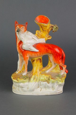 A Victorian Staffordshire spill vase in the form fo a fox carrying a dead bird 9" 