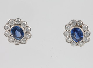 A pair of 18ct yellow gold sapphire and diamond oval cluster ear studs