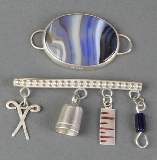 A hardstone and silver pendant, a ditto brooch