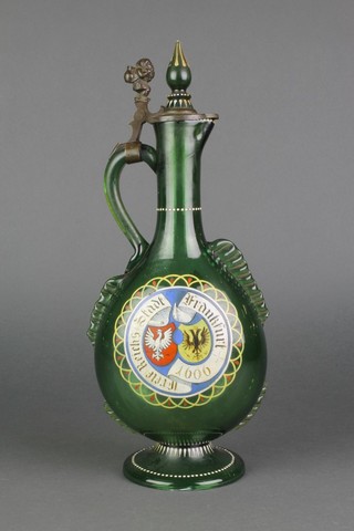 A 19th Century Continental green glass flattened ewer decorated crest and cathedral having a pewter mounted lid in the form of a gnome carrying a sack 15" 