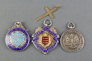A gold cross and 3 silver sports fobs