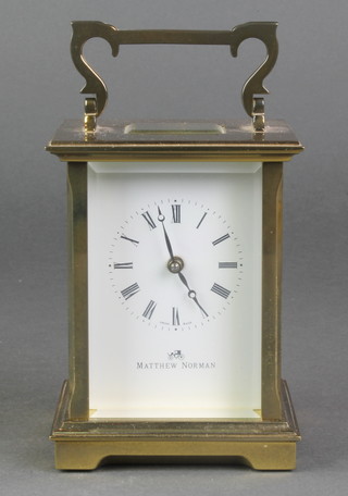 Matthew Norman, a 20th Century carriage timepiece with enamelled dial and Roman numerals contained in a gilt metal case 
