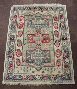 A Caucasian style white ground rug with stylised diamonds to the centre 76" x 55" 