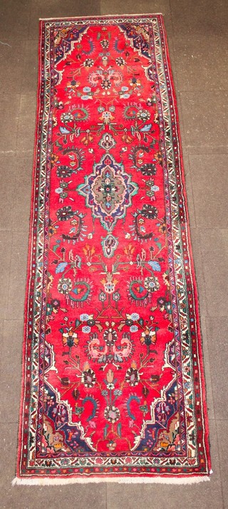 A red and blue ground Persian runner with floral decoration 119" x 34" 