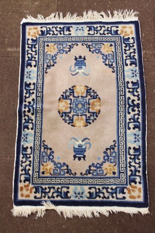 A white and blue ground Chinese slip rug 35" x 24"