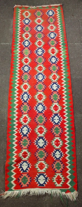 A red ground Kelim runner with all-over geometric design 100" x 31 1/2" 