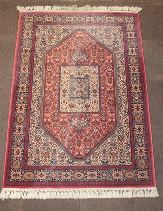 A pink ground Persian style machine made rug with diamond medallion to the centre with floral pattern 27" x 55" 