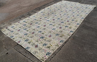 A machine made white ground carpet with garden design 282" x 143 1/2" 