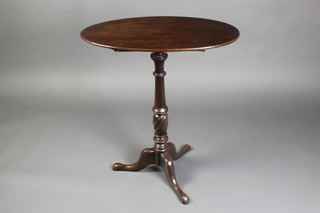 A 19th Century oval mahogany snap top wine table, raised on turned column and tripod base 31 1/2"h x 27 1/2"w x 17"d 