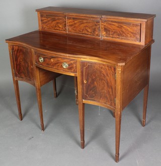 An Edwardian Georgian style sideboard with raised super structure to the back, the base of serpentine outline fitted 1 long drawer flanked by a pair of cupboards, raised on square tapering supports, spade feet 38"h x 43"w x 23 1/2"d 
