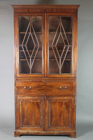 A 19th Century mahogany secretaire bookcase with associated top, the upper section with moulded cornice, fitted shelves enclosed by astragal glazed panelled doors, the base fitted a secretaire drawer above a cupboard fitted shelves enclosed by panelled doors, raised on bracket feet 88"h x 43 1/2"w x 16 1/2"d 