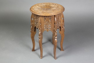 A circular Indian carved and pierced hardwood occasional table, the top carved peacocks, raised on 6 panel supports 20"h x 13 1/2" diam. 